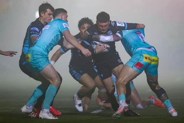 Glasgow's Cole Forbes (centre) is tackled during a European Champions Cup match between Glasgow Warriors and Exeter Chiefs
