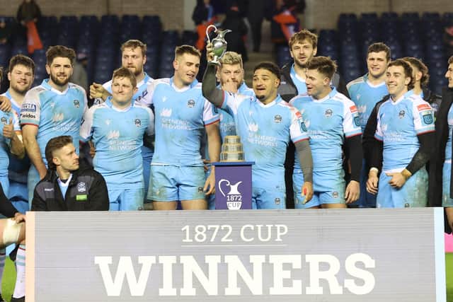 Glasgow Warriors' Sione Tuipulotu lifts the 1872 Cup after the aggregate win over Edinburgh in 2023. (Photo by Ross MacDonald / SNS Group)