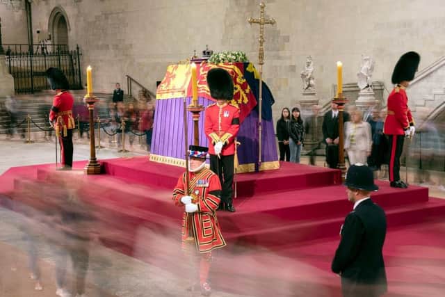 Members of the public file past the coffin of Queen Elizabeth II, draped in the Royal Standard with the Imperial State Crown and the Sovereign's orb and sceptre, lying in state on the catafalque in Westminster Hall at the Palace of Westminster. Picture: Getty Images