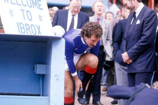Rangers chairman John Paton (right) looks on as new player/manager Graeme Souness laces his boots before taking to the Ibrox pitch for a photocall