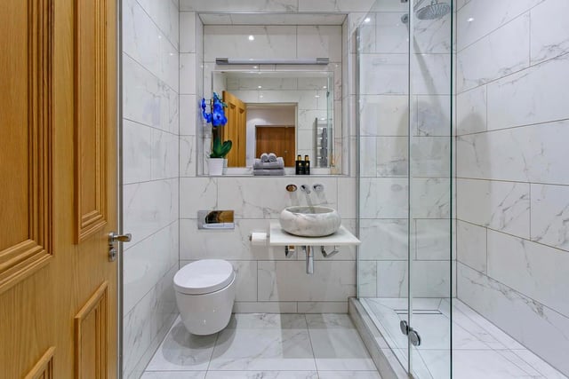 The bedroom has access to the Jack & Jill shower room which is finished with stunning marble effect tiles, under-floor heating, chrome fittings and a feature wash hand basin