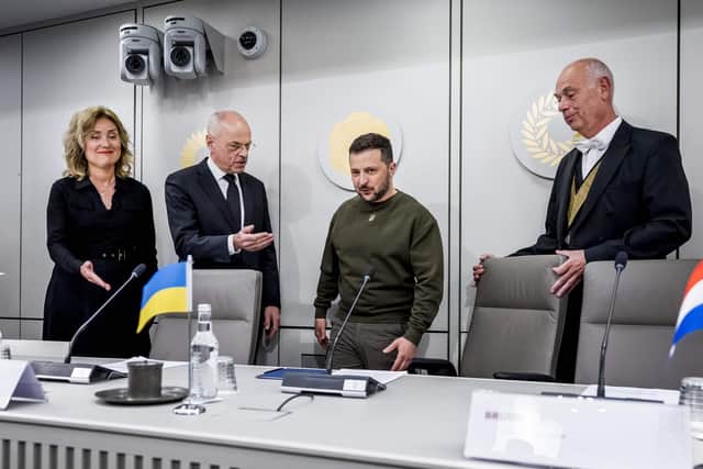 Ukrainian President Volodymyr Zelensky stands next to Dutch Senate president Jan Anthonie Bruijn and Dutch House of Representatives president Vera Bergkamp ahead of a meeting, in The Hague, as part of his first visit in Netherlands.