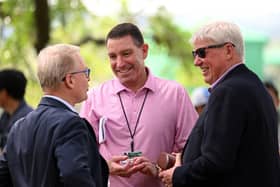 DP World Tour chief executive Keith Pelley, left, chats with agent Mark Steinberg, centre, and The R&A's CEO Martin Slumbers, right, during The Masters last year. Picture: Ross Kinnaird/Getty Images.