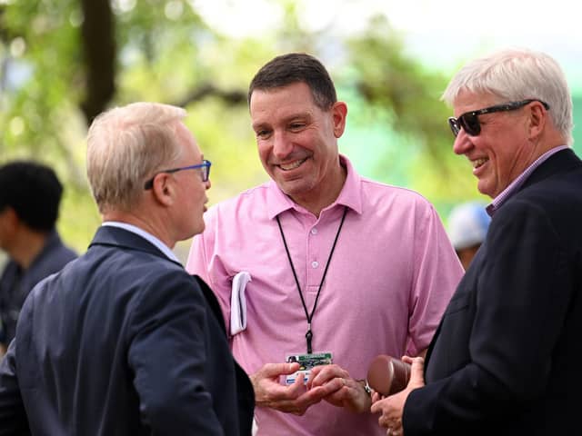 DP World Tour chief executive Keith Pelley, left, chats with agent Mark Steinberg, centre, and The R&A's CEO Martin Slumbers, right, during The Masters last year. Picture: Ross Kinnaird/Getty Images.
