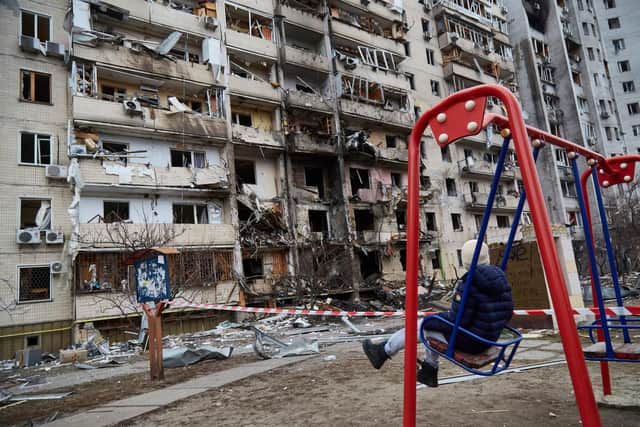 A child on a swing outside a residential building in Kyiv  damaged by a Russian missile strike. Picture: Pierre Crom/Getty