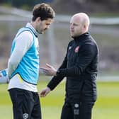 Hearts manager Steven Naismith speaks to Peter Haring during a training session.