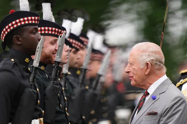 King Charles III inspects the guard of honour, Balaklava Company, 5th Battalion, the Royal Regiment of Scotland during the Ceremony of the Keys in the gardens of the Palace of Holyroodhouse in Edinburgh, as part of the King's visit to Scotland for Holyrood Week.
