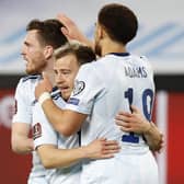 Scotland's forwrad Ryan Fraser (C) is congratulated for his goal by teammates Che Adams (R) and Andrew Robertson during the 2022 FIFA World Cup qualifier group F football match between Israel and Scotland at Bloomfield stadium in the Israeli Mediterranean coastal city of Tel Aviv on March 28, 2021. (Photo by JACK GUEZ / AFP) (Photo by JACK GUEZ/AFP via Getty Images)