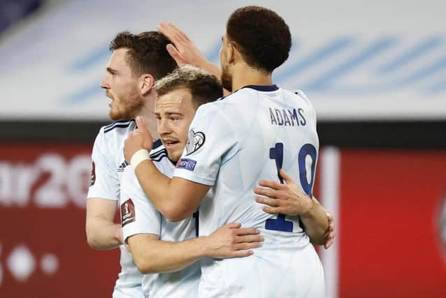 Scotland's forwrad Ryan Fraser (C) is congratulated for his goal by teammates Che Adams (R) and Andrew Robertson during the 2022 FIFA World Cup qualifier group F football match between Israel and Scotland at Bloomfield stadium in the Israeli Mediterranean coastal city of Tel Aviv on March 28, 2021. (Photo by JACK GUEZ / AFP) (Photo by JACK GUEZ/AFP via Getty Images)