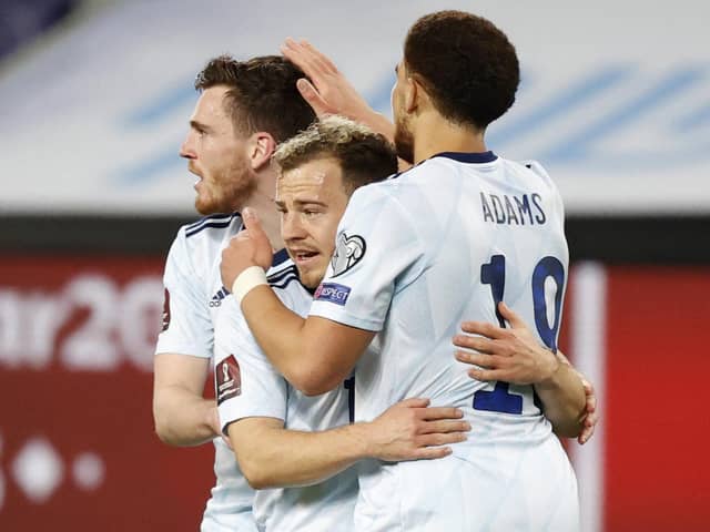 Scotland's forwrad Ryan Fraser (C) is congratulated for his goal by teammates Che Adams (R) and Andrew Robertson during the 2022 FIFA World Cup qualifier group F football match between Israel and Scotland at Bloomfield stadium in the Israeli Mediterranean coastal city of Tel Aviv on March 28, 2021. (Photo by JACK GUEZ / AFP) (Photo by JACK GUEZ/AFP via Getty Images)