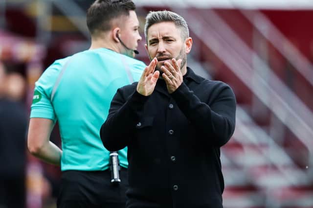 Hibs boss Lee Johnson watched his team lose 2-1 to Motherwell at Fir Park.
