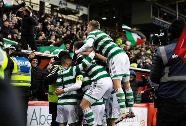Celtic players celebrate widly Callum McGregor's clincher against Aberdeen that has created a first in the Ange Postecoglou era, (Photo by Craig Williamson / SNS Group)
