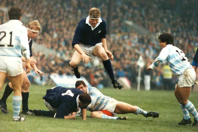 Doddie Weir leaps into support Chris Gray, who has been tackled by an Argentinian forward during the match at Murrayfield on September 9, 1990.
