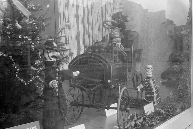 The window display at the Music Hall, on George Street, just before Christmas 1962 featured Punch and Judy figures and a mechanical train.