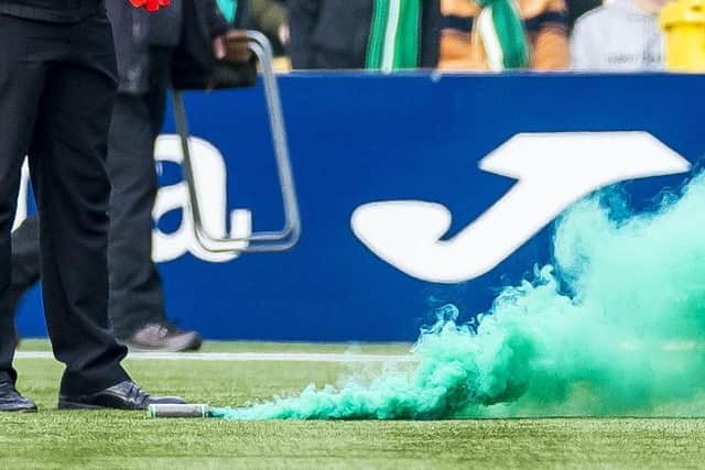 A smoke bomb was thrown on to the artificial surface at Livingston.