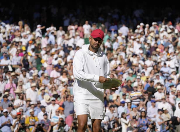 Australia's Nick Kyrgios pretends to use the runners-up trophy as a frisbee after losing to Serbia's Novak Djokovic in the final of the men's singles.