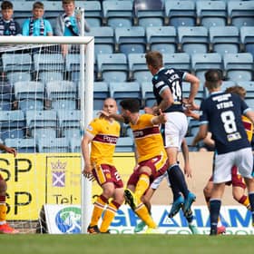 Lee Ashcroft heads home Dundee's winning goal. Picture: SNS