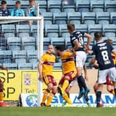 Lee Ashcroft heads home Dundee's winning goal. Picture: SNS