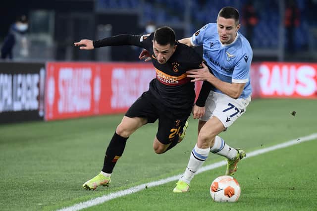 Lazio's Montenegrin midfielder Adam Marusic (R) holds back Galatasaray's Romanian midfielder Olimpiu Morutan.