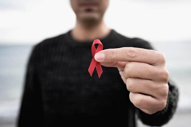 The red ribbon is worn as a symbol of awareness and solidarity on World Aids Day (Shutterstock)