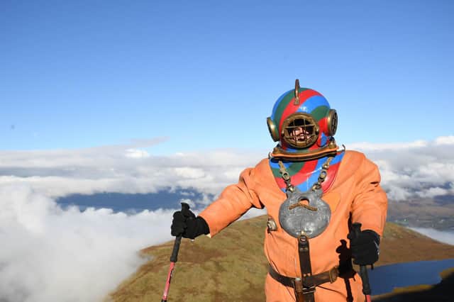 Veteran fundraiser Lloyd Scott, who is attempting to climb the Three Peaks whilst wearing a deep sea diving suit, during his challenge on Ben Nevis on Monday