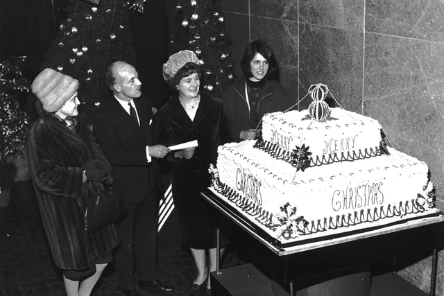 Staff at Edinburgh department store Goldberg's unveil their giant Christmas cake in 1962.
