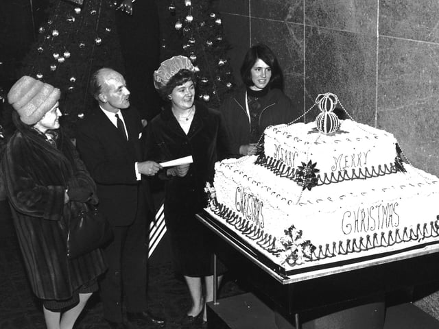 Staff at Edinburgh department store Goldberg's unveil their giant Christmas cake in 1962.