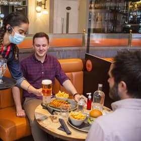 Patrons are served in The Huxley in Edinburgh in line with parts of the country moving into level two restrictions, while Glasgow remains in level three. Picture: Lisa Ferguson