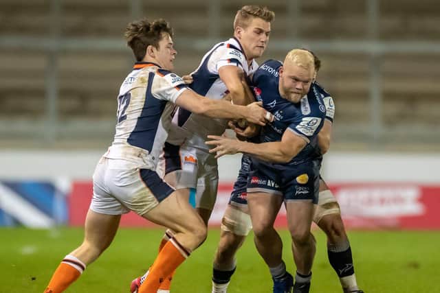 Duhan van der Merwe, centre in white, tries to wrestle the ball from his brother Akker during Edinburgh's 16-15 win over the Sale Sharks at the AJ Bell Stadium in the European Champions Cup in 2020. Mandatory Credit: (Photo by Roger Evans/Action Plus/Shutterstock)