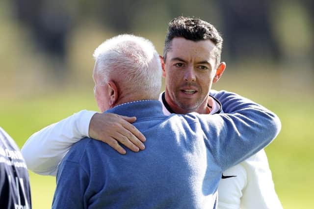 Rory McIlroy embraces his father Gerry after their opening round in the Alfred Dunhill Links Championship at Carnoustie Golf Links. Picture: Richard Heathcote/Getty Images.
