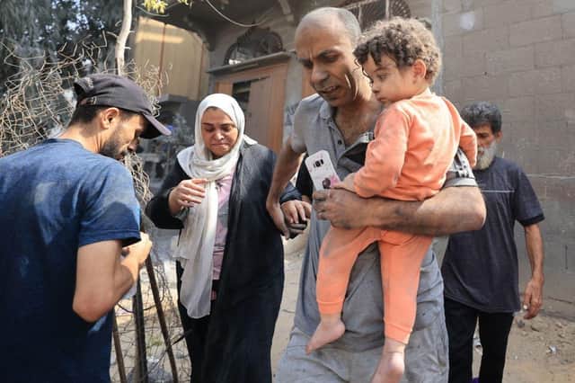 Palestinians evacuate the area following an Israeli airstrike on the Sousi mosque in Gaza City on October 9, 2023. Israel continued to battle Hamas fighters on October 9 and massed tens of thousands of troops and heavy armour around the Gaza Strip after vowing a massive blow over the Palestinian militants' surprise attack. (Photo by Mahmud HAMS / AFP) (Photo by MAHMUD HAMS/AFP via Getty Images)