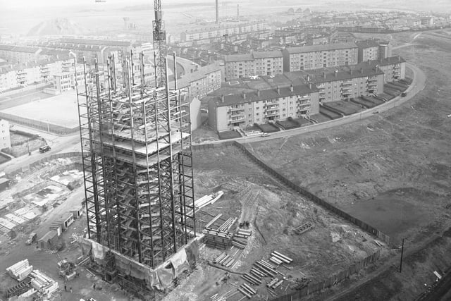 A view showing a tower crane used by Stewart Plant Ltd at work on a block of flats in Glasgow, 1966.