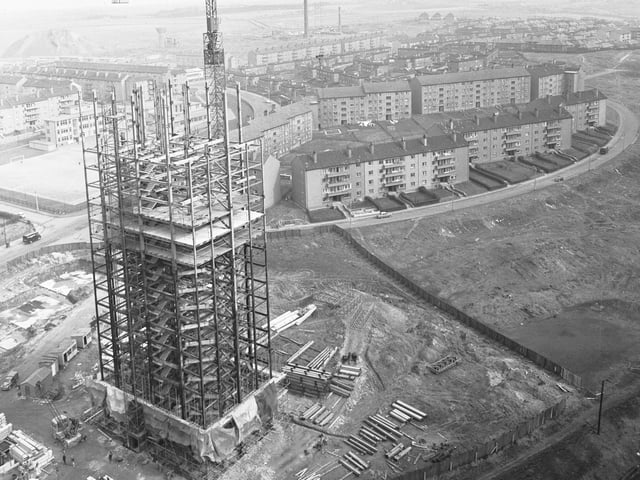 A view showing a tower crane used by Stewart Plant Ltd at work on a block of flats in Glasgow, 1966.