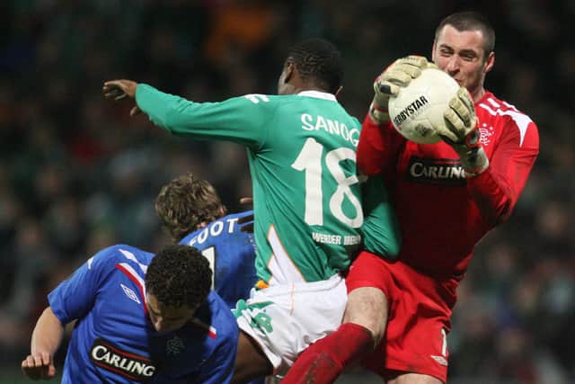 Allan McGregor defies Werder Bremen striker Boubacar Sanogo during Rangers' UEFA Cup last 16 tie in Germany in March 2008. (Photo by John MacDougall/AFP via Getty Images)