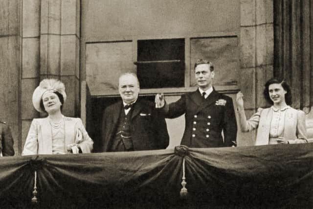 Prime Minister Winston Churchill with Princess Elizabeth, Queen Elizabeth, King George VI, and Princess Margaret, waving from the balcony of Buckingham Palace on VE-Day, 8 May 1945. (Photo by Culture Club/Getty Images)