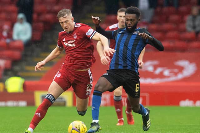 Aberdeen's Ross McCrorie competes with Hearts' Beni Baningime at Pittodrie.