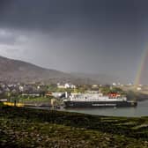 A rainbow over the MV Hebrides as it docks at Tarbert,on the Outer Hebrides from the book Scotland's Islands. Photographed and published by Allan Wright Photographic