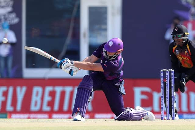 Scotland's George Munsey plays a shot during the ICC mens Twenty20 World Cup cricket match between Scotland and Papua New Guinea at the Oman Cricket Academy Ground in Muscat on October 19, 2021. (Photo by Haitham AL-SHUKAIRI / AFP) (Photo by HAITHAM AL-SHUKAIRI/AFP via Getty Images)
