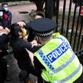 Police try to pull a Hong Kong pro-democracy protester out of the grounds of the Chinese consulate in Manchester (Picture: Matthew Leung/The Chaser News/AFP via Getty Images)