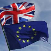 An EU flag and a Union flag held by a demonstrator is seen with Elizabeth Tower (Big Ben) and the Houses of Parliament. Picture: Daniel Leal-Olivas/AFP via Getty Images