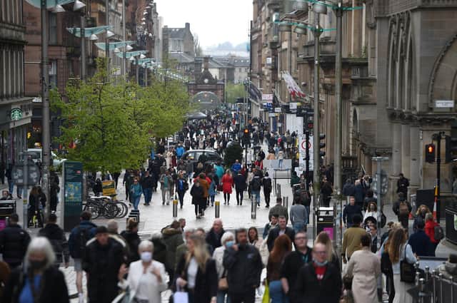 Pedestrians walk past re-opened shops and businesses in Glasgow. Photo by ANDY BUCHANAN/AFP via Getty