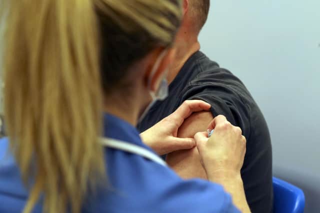 A person receiving a Covid-19 jab. Picture: PA Media