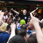 Scottish fans gather in Leicester Square in central London, ahead of the UEFA Euro 2020 match between England and Scotland at Wembley Stadium. Picture date: Friday June 18, 2021.