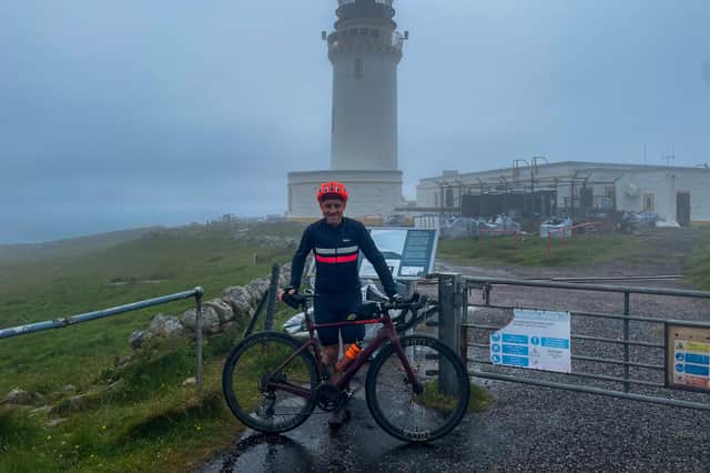 Endurance athlete Donnie Campbell at Cape Wrath lighthouse, after smashing the record for the An Turas Mor mountain bike route from Glasgow