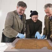 John McLeish, chair of the Scottish Tartans authority, V&A Dundee curator James Wylie and tartan historian Peter MacDonald have a close look at the Glen Affric tartan. Picture: Alan Richardson