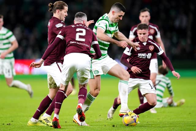 Tom Rogic (centre) controls the ball surrounded by Hearts players on his return to the Celtic team. (Jane Barlow/PA Wire)