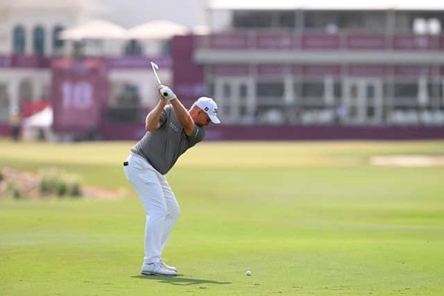 Stephen Gallacher plays his second shot on the 18th hole during the first round of the Commercial Bank Qatar Masters. Picture: Ross Kinnaird/Getty Images.