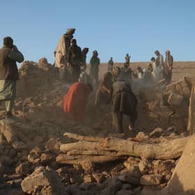 Afghan residents clear debris from a damaged house after earthquake in Sarbuland village of Zendeh Jan district of Herat province (Photo by Mohsen KARIMI / AFP) (Photo by MOHSEN KARIMI/AFP via Getty Images)