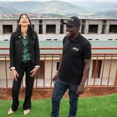 Home Secretary Suella Braverman laughs as she tours a building site on the outskirts of Kigali, Rwanda, where deported migrants are planned to be housed (Picture: Stefan Rousseau/PA)