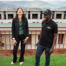 Home Secretary Suella Braverman laughs as she tours a building site on the outskirts of Kigali, Rwanda, where deported migrants are planned to be housed (Picture: Stefan Rousseau/PA)